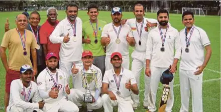  ??  ?? The Penang Cricket Associatio­n 30 Overs League champions celebrate their victory at the Penang Sports Club recently. PIC BY K.KANDIAH