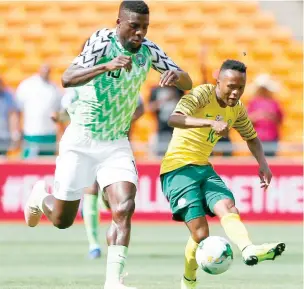  ??  ?? One of the invied players John Ogu (left) vies with a South African defender during the 2019 Africa Cup of Nations Group E qualifier at FNB Stadium