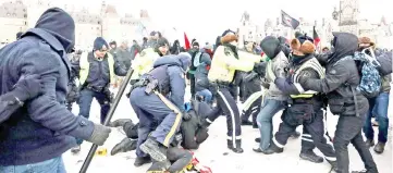  ??  ?? Police clash with counter-protesters during a far-right rally against the UN migration pact on Parliament Hill in Ottawa, Ontario. — Reuters photo