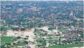  ?? — PTI ?? Aerial view of the flood-affected area as seen by Assam Chief Minister Himanta Biswa Sarma during his survey, in Silchar.