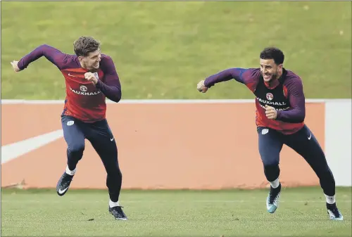  ?? PICTURE: MIKE EGERTON/PA WIRE ?? QUICK OUT OF THE BLOCKS: England’s John Stones, left, and Kyle Walker laugh and joke during a sprint in England’s training session in Burton.