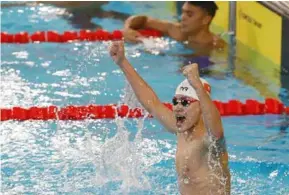  ?? VNA/VNS Photo Phạm Kiên ?? DELIGHT: Phạm Thanh Bảo celebrates his men's 100m breaststro­ke win at the 31st SEA Games in Hà Nội on Saturday.