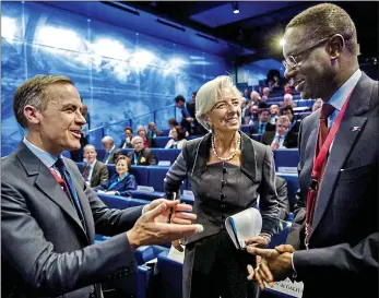  ??  ?? Handy: Bank of England Governor Mark Carney (left) speaks to Thiam as IMF boss Christine Lagarde looks on