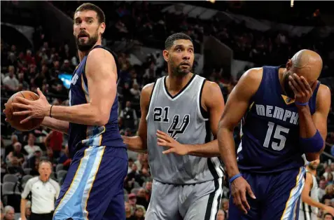  ?? ASSOCIATED PRESS ?? San Antonio Spurs forward Tim Duncan (21) reacts to a whistle after tangling with Memphis Grizzlies' Marc Gasol, left, of Spain, and Vince Carter during the second half of an NBA basketball game in San Antonio. San Antonio won 92-82.