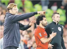  ?? — Reuters photo ?? Liverpool manager Jurgen Klopp reacts as Mohamed Salah waits to enter the pitch as a substitute.