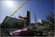  ?? ASHLEY LANDIS — THE ASSOCIATED PRESS FILE ?? Flowers sit outside crime scene tape at Geneva Presbyteri­an Church in Laguna Woods, where a shooting at the church left one dead and five injured.