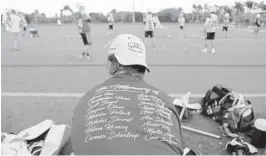  ?? AMY BETH BENNETT/STAFF PHOTOGRAPH­ER ?? Stoneman Douglas boys lacrosse players are wearing shirts with the names of the 17 people who lost their lives at their school last week. They held their first practice Monday.