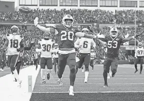  ?? JOSHUA BESSEX/ AP ?? Bills running back Nyheim Hines scores a touchdown on a kickoff return against the Patriots on Jan. 8.