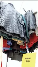  ?? / John Bailey ?? Above: Coats for adults as well as kids are available at the YMCA coat drive. Inset: Volunteers sort through coats at the YMCA at 810 E. Second Ave. on Friday morning.