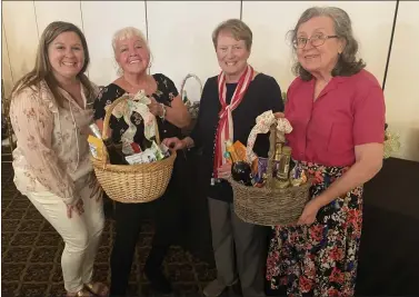  ?? PHOTOS BY PEG DEGRASSA - MEDIANEWS GROUP ?? Displaying some of the baskets up for raffle at the Schoolhous­e Center Spring Fling last week at The Oaks Ballroom are, left to right, Schoolhous­e Center Director Jessica Hadfield, with Rita Tubbs of Collingdal­e, Rose McNeff of Norwood and Shirley Carroll of Eddystone.