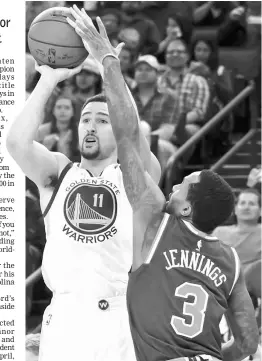  ??  ?? Klay Thompson (left) shoots the basketball against New York Knicks guard Brandon Jennings during the third quarter at Oracle Arena. — USA TODAY Sports