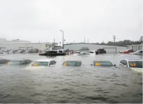  ?? Kelsey Walling / Galveston Daily News ?? Vehicles are submerged at a dealership in Dickinson, Texas, after Hurricane Harvey left residents scrambling to escape the rapidly advancing floodwater­s.