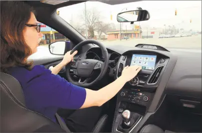  ?? Ford Motor Co. / New York Times ?? A motorist uses Ford’s Sync 3 in-dashboard system.