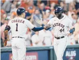  ?? DAVID J. PHILLIP/AP ?? Carlos Correa greets Yordan Alvarez after Alvarez’s solo home run during the Astros’ 6-1 victory over the White Sox in Game 1 of the ALDS on Thursday.