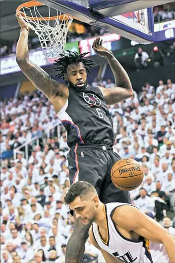  ?? Gene Sweeney Jr./Getty Images ?? Los Angeles’ DeAndre Jordan scores in Game 6 Friday night in Salt Lake City. He has had a double-double in every game in the series against Utah.