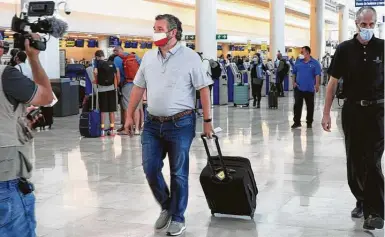  ?? MEGA / GC Images ?? U.S. Sen. Ted Cruz checks in Thursday for a flight back to Houston at Cancún Internatio­nal Airport in Mexico.