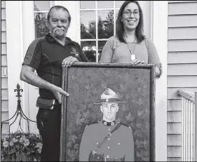  ?? DARRELL COLE – SALTWIRE NETWORK ?? Portraits of Honour artist Dave Sopha presents a painting of the late RCMP officer Const. Frank Deschenes to his widow Savannah during a ceremony at her Riverview, N.B. home on June 21. Deschenes was killed near Memramcook, N.B., last October while...