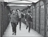  ?? RAYMOND CAUCHETIER/LA GALERIE DE L’INSTANT ?? A photo Raymond Cauchetier took on the set of François Truffaut’s 1962 movie “Jules and Jim,” showing Jeanne Moreau — with a fake mustache — chased by Henri Serre and Oskar Werner.