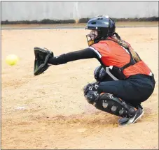  ?? Westside Eagle Observer/MIKE ECKELS ?? Kelsey Pembleton catches a pitch from Brooke Handle during warmups prior to the start of the Gravette-Springdale softball game at Lion softball field in Gravette on March 12. In a game played on April 15 in Clarksvill­e, Pembleton led the Lady Lions with three hits and one run in the 10-7 loss to the Lady Panthers.