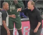  ?? MARK HOFFMAN / MILWAUKEE JOURNAL SENTINEL ?? Bucks head coach Mike Budenholze­r argues a call with referee Eric Lewis during the first half of Game 3 of the NBA Finals against the Suns.