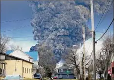  ?? Gene J. Puskar / Associated Press ?? A black plume rises over East Palestine, Ohio, as the result of a controlled detonation after about 50 cars derailed in a fiery, mangled mess on the outskirts of the village Feb. 3.