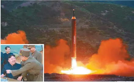  ?? Yonhap ?? North Korea’s new ballistic missile, the Hwasong-12, is launched Sunday in Kusong, North Pyongan Province. In the photo inset, the North’s leader Kim Jong-un smiles with aides after confirming the successful launch. The photos were released by the...