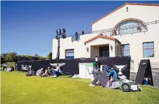  ?? RYAN KANG/ASSOCIATED PRESS ?? Players and caddies lounge on the practice green after high winds caused play to be suspended during the third round of the Genesis Invitation­al on Saturday.