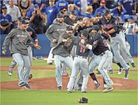  ?? DAN HAMILTON, USA TODAY SPORTS ?? The Indians exult Wednesday after beating the Blue Jays to win their first American League Championsh­ip Series since 1997.