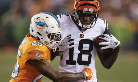  ?? AP FILE ?? BARGAIN SHOPPING: Cincinnati Bengals wideout A.J. Green is tackled by Miami Dolphins cornerback Xavien Howard.