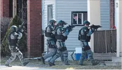  ?? BARRY GRAY THE HAMILTON SPECTATOR ?? Police on alert at a home on Victoria Avenue South Friday afternoon after a firearms report. Roads were closed. Two “persons of interest” were detained.