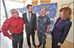  ?? Dan Watson/The SIgnal ?? Applied Companies representa­tives, from left, Greg Rogozinski, program manager; Steve Stanley, vice president operations and engineerin­g; and Betsy Klinger, president, right, meet with United States Navy Capt. Patrick Croley in their lobby in Valencia on Wednesday, as the Navy recognized the company for their developmen­t of an environmen­tal control unit.