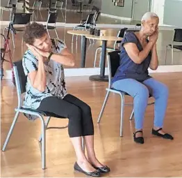  ?? PHOTOS BY JAYDA HALL/STAFF ?? Doris Sternberg, 76, of Boca Raton, and Patricia Perry, 72, of Delray Beach, participat­e in a warm-up exercise during dance class at Arthur Murray Dance Studio in Boca Raton.