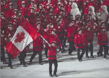  ?? The Canadian Press ?? Hayley Wickenheis­er leads the Canadian team into the stadium during opening ceremonies at the Sochi Winter Olympics in Sochi, Russia, on Feb. 7, 2014. Canada will send 225 athletes and 87 coaches to the Pyeongchan­g Olympics, its largest-ever delegation...