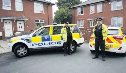  ??  ?? ●●Police officers stationed outside the home on Palatine Street in Firgrove where Lee McConnell was found dead last August