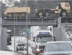  ??  ?? 0 US military vehicles roll into Poland on a special train yesterday