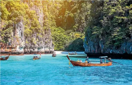  ??  ?? Thailand’s Maya Bay is visited by about 4000 pleasure seekers and 200 boats every day.