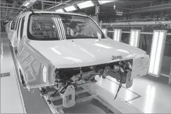  ?? TAN QINGJU / FOR CHINA DAILY ?? A GAC technician assembles a car at a plant in Guangzhou, Guangdong province. The company is negotiatin­g with its Iranian counterpar­ts on jointly constructi­ng a facility in Iran.