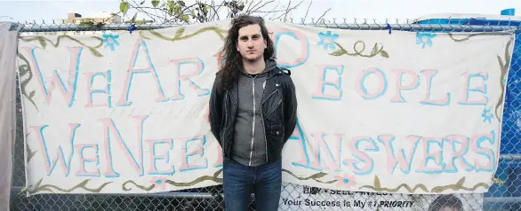  ?? GERRY KAHRMANN ?? J.J. Riach, an organizer with the Alliance Against Displaceme­nt, stands outside the Sugar Mountain camp on Franklin Street on Thursday. Riach says the residents don’t want to follow a city order to vacate the tent camp by Friday until they’ve been...