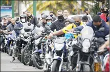  ??  ?? Motorcycli­sts wearing masks amid the new coronaviru­s pandemic wait their turn to fill up at a gas station in Caracas, Venezuela on Sept 8. Gasoline shortages have returned to Venezuela, sparking mile-long lines in the capital as internatio­nal concerns mounted that Iran yet again may be trying
to come to the South American nation’s rescue. (AP)