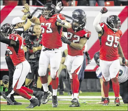  ?? CURTIS COMPTON / CCOMPTON@AJC.COM HYOSUB SHIN / HSHIN@AJC.COM ?? The Falcons’ Ben Garland (63) celebrates his sack of Seattle QB Russell Wilson for a safety in the second quarter. Keanu Neal (22) and Jonathan Babineaux (95) join in. Babineaux had one of three sacks of Wilson and was one of several spies the team...