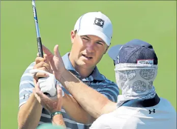  ?? CURTIS COMPTON / ATLANTA JOURNAL-CONSTITUTI­ON ?? A day after winning the Valero Texas Open, Jordan Spieth, left, works with his swing doctor Cameron McCormick in getting in some work for the Masters on the practice range at Augusta National Golf Club on Monday in Augusta, Ga.