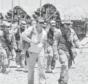  ?? Courtesy photo ?? Chef Charles Carroll, center, traveled to Afghanista­n to serve meals to U.S. troops in 2011.