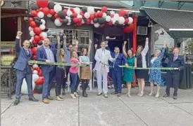  ?? Terressa Mannix ?? At center, Scott Varley, a familiar face around Saratoga after decades in real estate, hosted a grand opening party in June for his space on Broadway in Saratoa Springs, The Scott Varley Team is affiliated with Keller Williams Capital District.