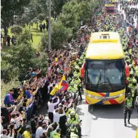  ?? AP ?? Fans gather along the route of the bus carrying Colombian players after they returned home on Friday from the World Cup. —