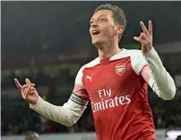  ?? AFP ?? Arsenal midfielder Mesut Ozil celebrates after scoring their first goal against Leicester City at the Emirates Stadium. —