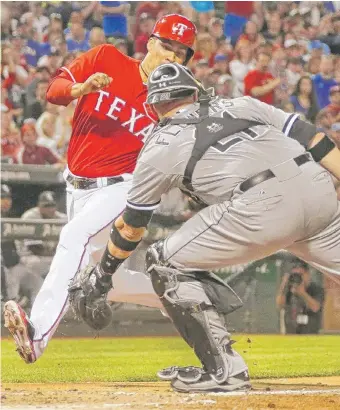  ?? | AP ?? Catcher Tyler Flowers waits in vain for a throw as the Rangers’ Robinson Chirinos scores in the fourth inning of the Sox’ 6-3 loss.