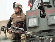  ?? — AFP ?? Iraqi pro-government forces patrol in the eastern part of the embattled Iraqi city of Mosul on Tuesday during an ongoing military operation against IS cadres.