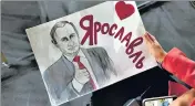  ?? ?? An attendee holds a poster of Russian President Vladimir Putin ahead of his annual address in Moscow on Thursday.