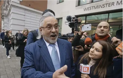  ??  ?? Vijay Mallya interacts with the media outside the Westminste­r Magistrate­s Court before the start of his extraditio­n hearing on Monday. — AFP