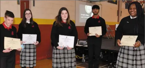  ??  ?? English award winners Aaron McKenna, Naoise Gray-Duff, Aisling Menary, Abneer Khokar and Nasya Igelige after receiving their certificat­es at the Ó Fiaich College Junior Cycle Awards Ceremony. Pictures Ken Finegan/Newspics